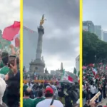 Aficionados con playeras de la selección y banderas de México celebran alrededor del Ángel de la Independencia.